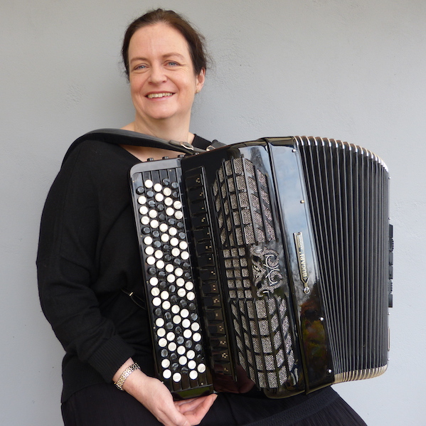 Image of lady with accordion with plain grey background